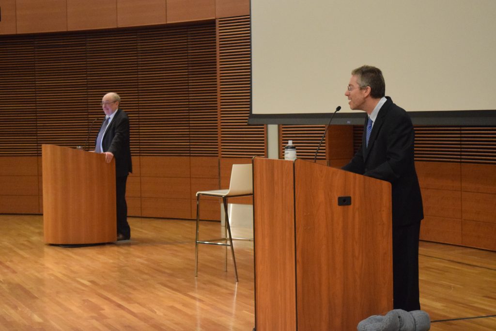 Debaters Brian Leiter and Bryan Caplan talk during their socialism, social democracy and capitalism debate.
