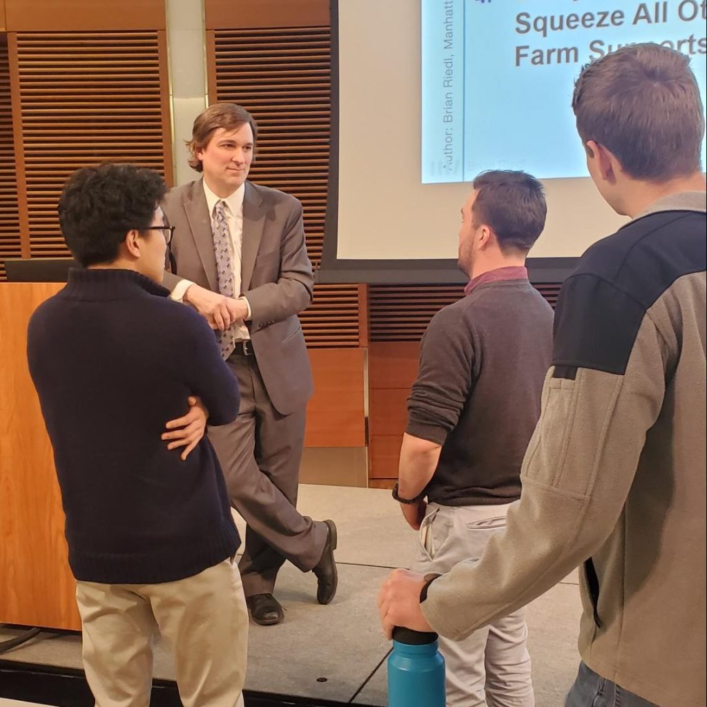 photo of speaker speaking with students