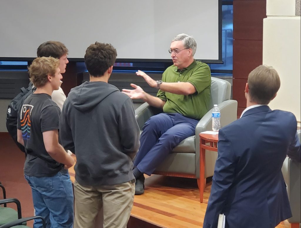 A photo of the speaker talking with students